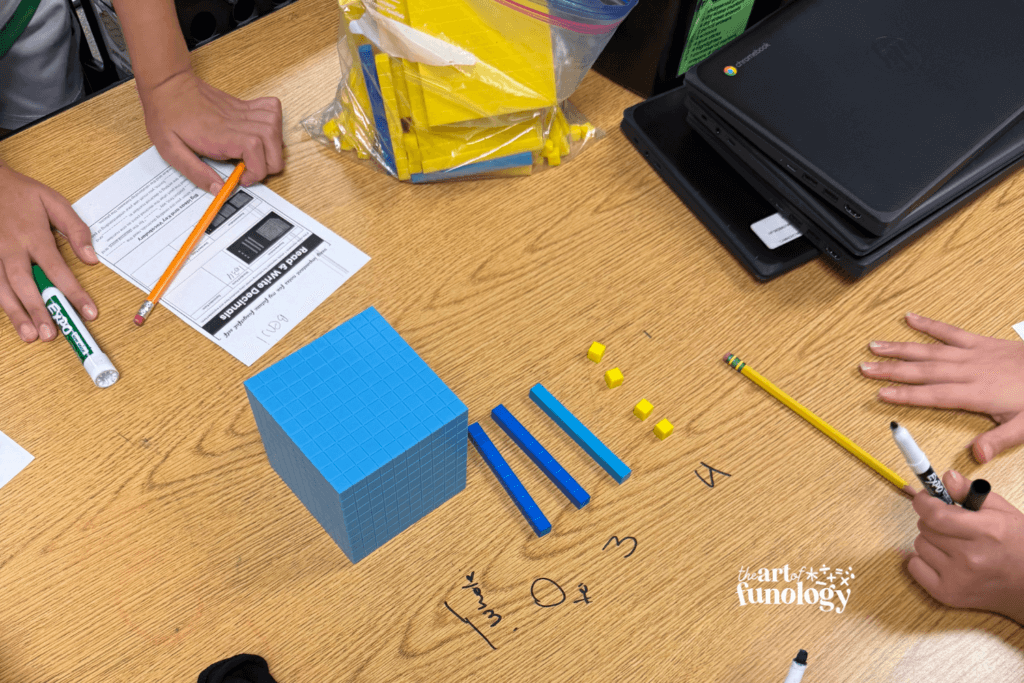 Students using base-ten blocks to model decimal place value in 5th grade